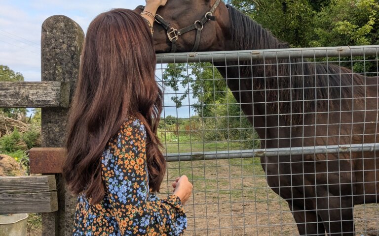 Gemma petting a horse